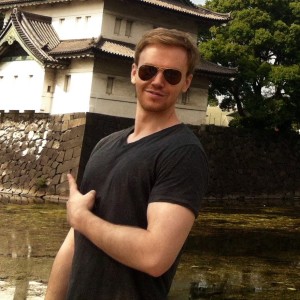 Benjamin McEvoy somewhere in Tokyo pointing at a temple